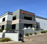 Photo of the front of a two-story industrial building with a Busch Vacuum sign on top of the building.