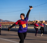 woman posing while running on a bridge