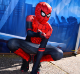 A person dressed in a Spiderman costume poses for the camera at Tempe FanCon.