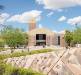 A photo of the front of the library building on a sunny day.